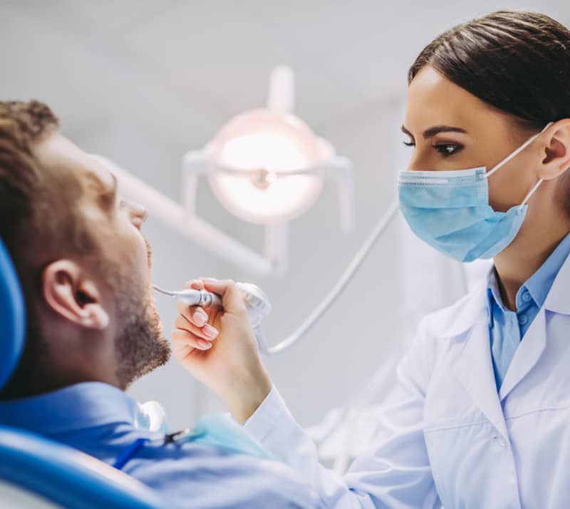 dentist examining patient before implant therapy