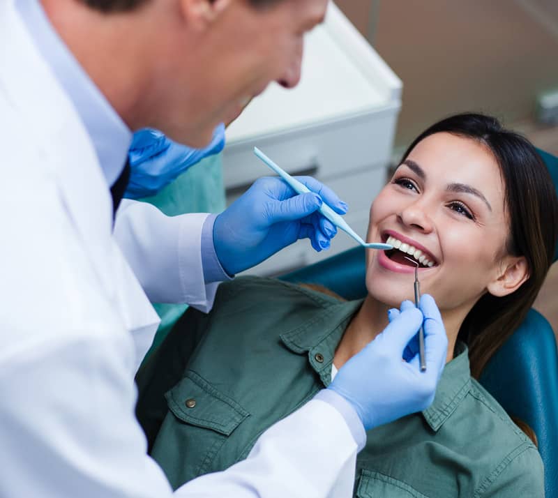 dentist performing dental bridge therapy
