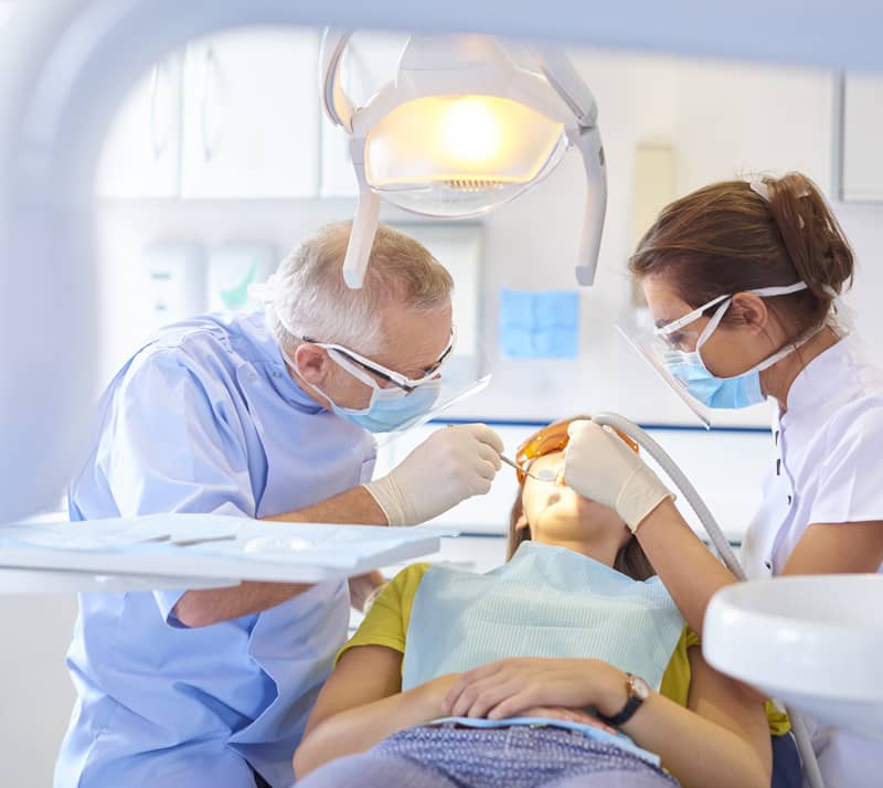 dentist performing root canal therapy