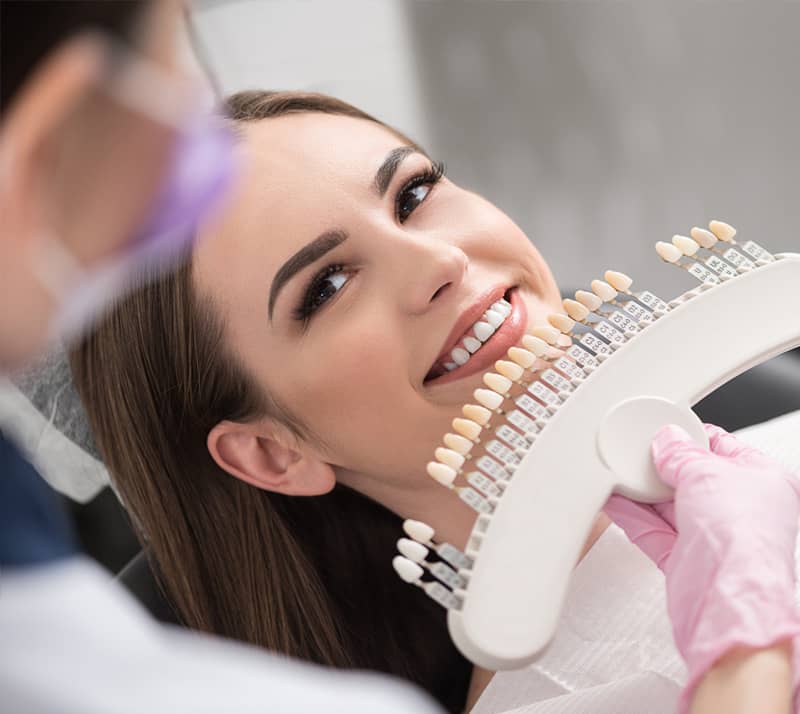 girl smiling before receiving porcelain veneer