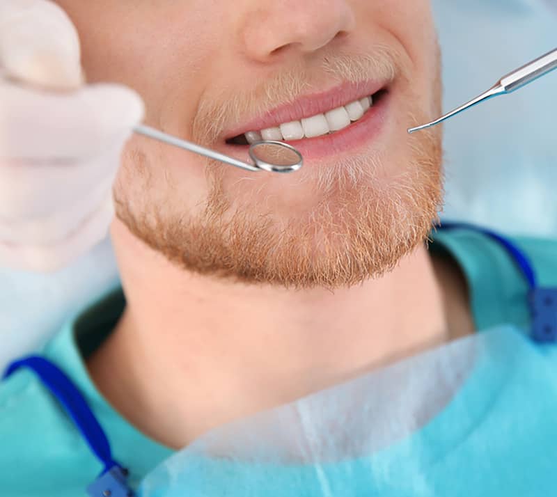 man at dentist chair for dental restoration