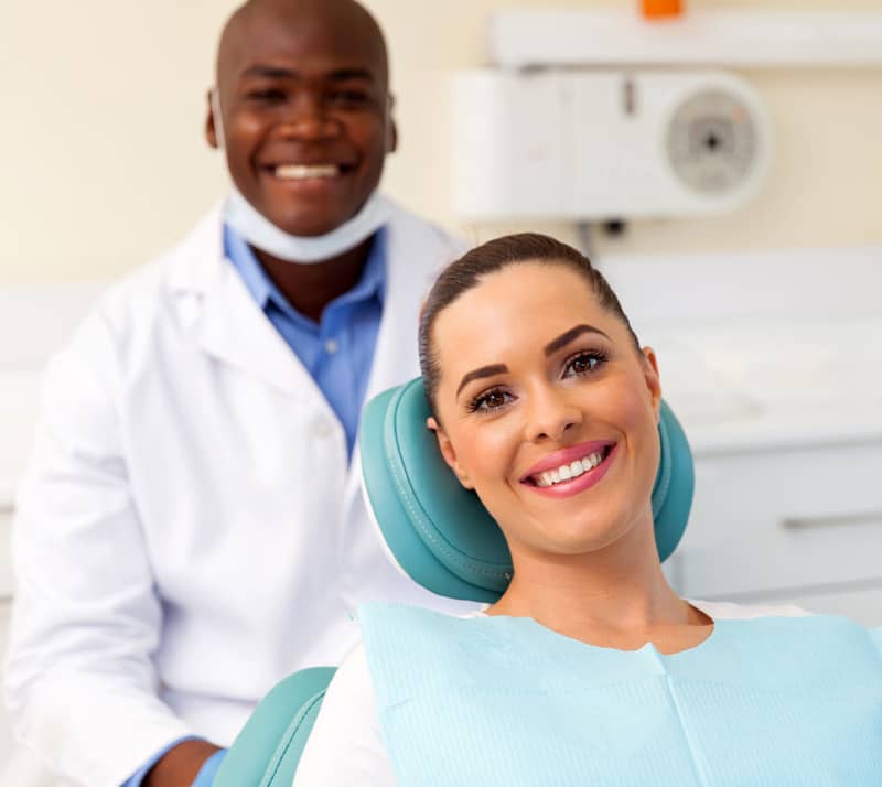 woman with cosmetic dentist smiling